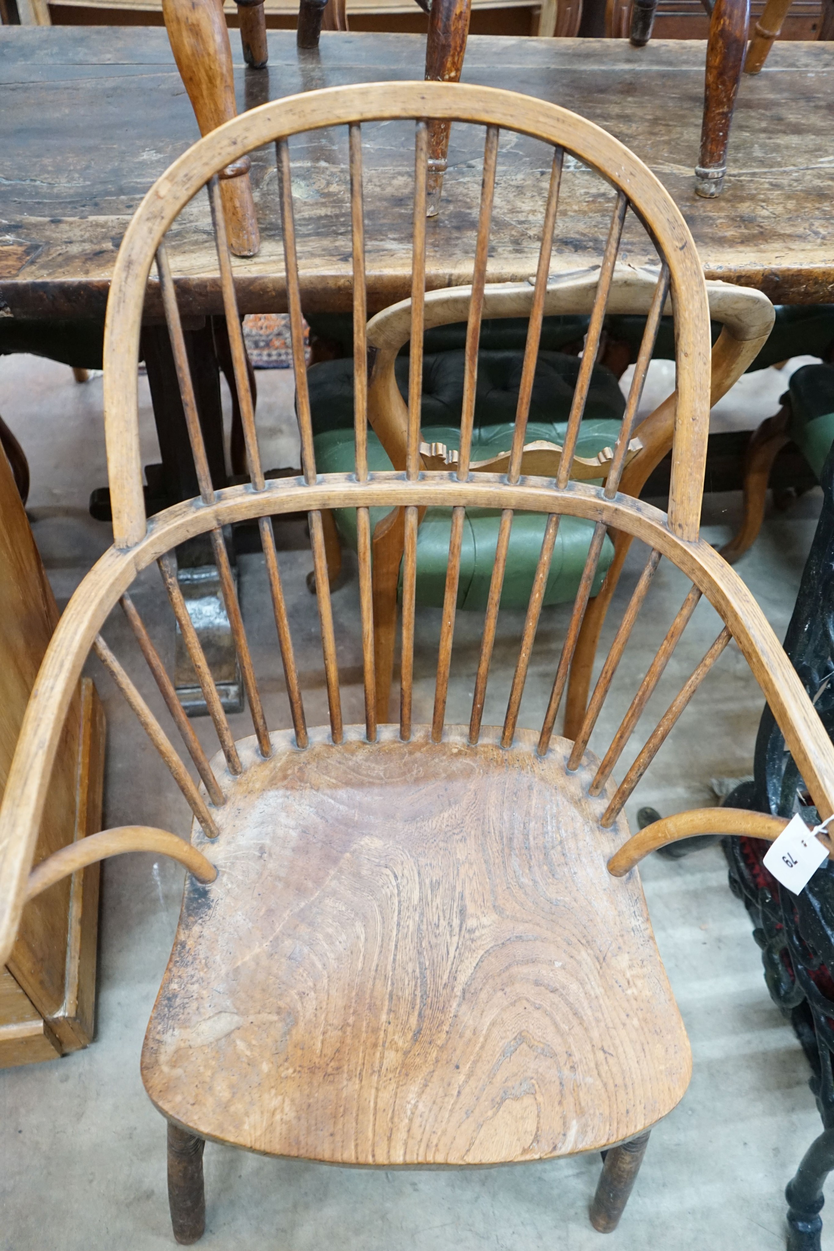 A late 19th / early 20th century elm and beech Windsor comb back elbow chair, width 64cm, depth 43cm, height 104cm